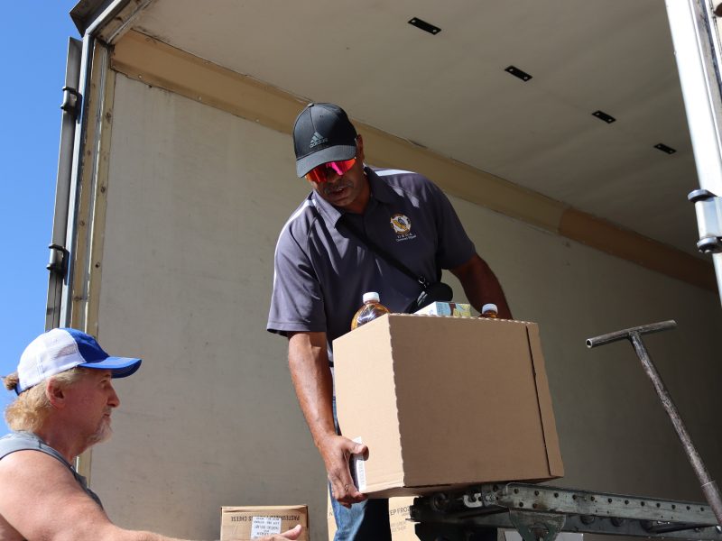 Assistant Director Ronald Buckman handing the last of one distribution to tribal staff.