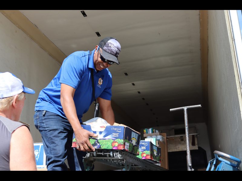Beginning of distribution, good conversations, good friends, good food,
always a happy occasion. Ronald Buckman helping tribal member Tiger Paulk unloading goods for the California Valley Miwok Tribe.