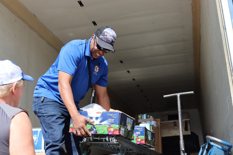 Beginning of distribution, good conversations, good friends, good food,
always a happy occasion. Ronald Buckman helping tribal member Tiger Paulk unloading goods for the California Valley Miwok Tribe.