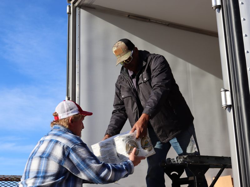 Ronald Buckman handing staff products included in distribution.