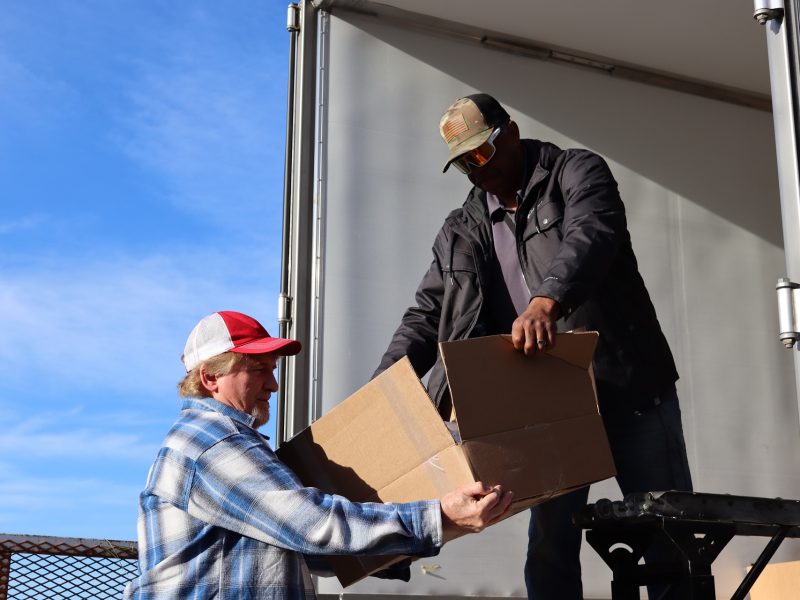 Ronald Buckman handing staff the last of one recipients distribution.