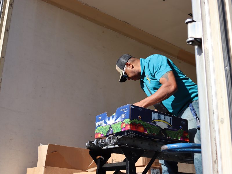 Here A.D. Ronald Buckman is looking for what else has to be included in another distribution. Ronald Buckman helping Tiger Paulk unloading goods during the USDA food distribution in October 2024.