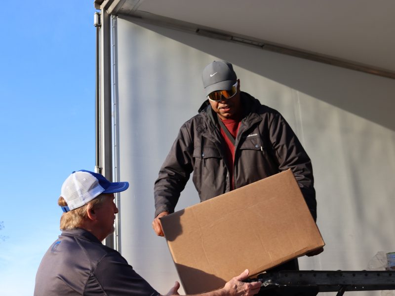 Ronald Buckman handing the last of one distribution to tribal staff.