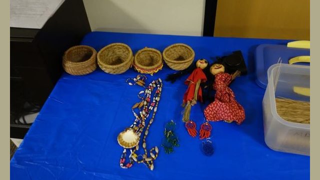 Some items handmade by tribal elder/artisan Mildred Burley for display at the event show basket weaving, jewelry and doll making. Many items pictured were gifted to participating attendees of the event.